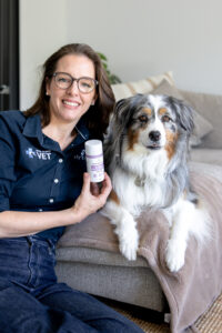 Dr. Nicole Rous with a dog and the Shy Tiger stress support supplement designed to help support calm behaviour and nervous system health in dogs.